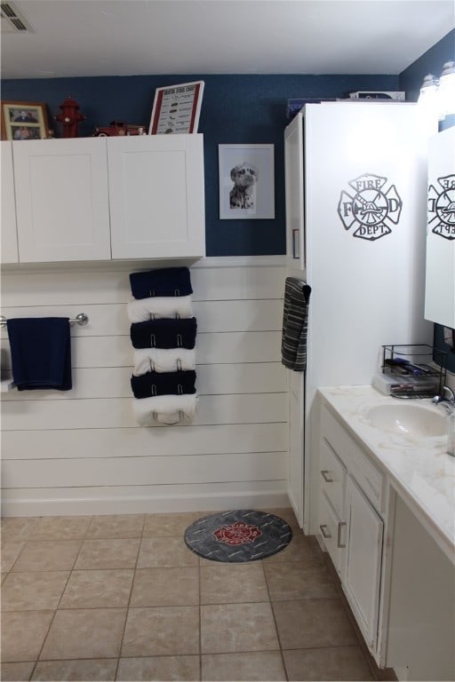 bathroom with tile patterned flooring and vanity