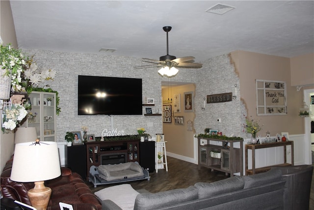 living room featuring ceiling fan and wood-type flooring