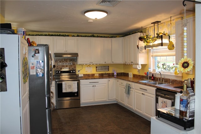 kitchen featuring stainless steel appliances, sink, tasteful backsplash, decorative light fixtures, and white cabinets