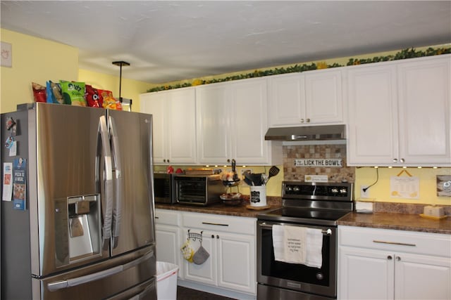 kitchen with white cabinets, appliances with stainless steel finishes, and backsplash