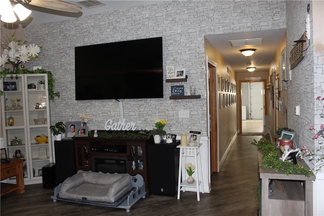 living room with dark hardwood / wood-style floors and ceiling fan