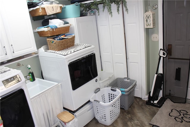 washroom featuring washer / clothes dryer, cabinets, and dark hardwood / wood-style floors