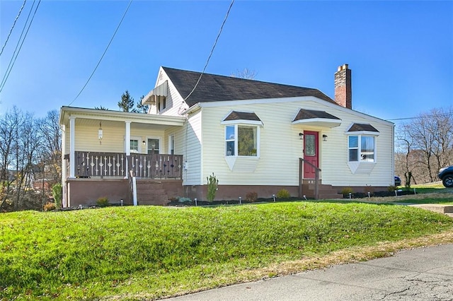 bungalow-style home with a porch and a front yard