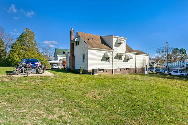 view of home's exterior featuring cooling unit and a lawn