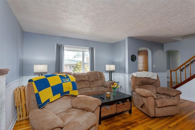 living room featuring hardwood / wood-style floors and a textured ceiling