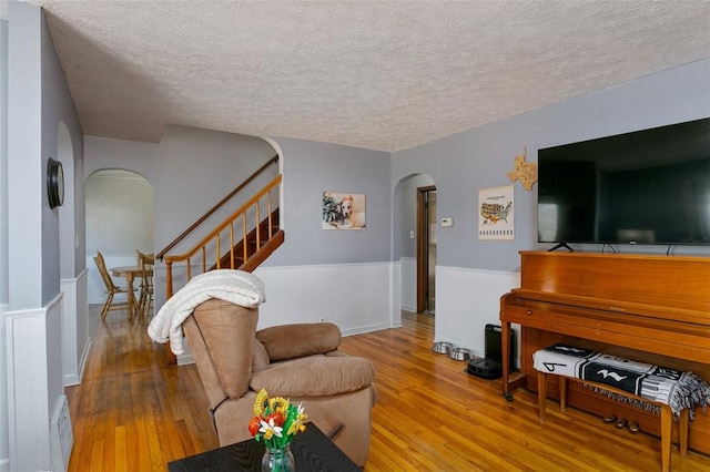 living room featuring a textured ceiling and hardwood / wood-style flooring