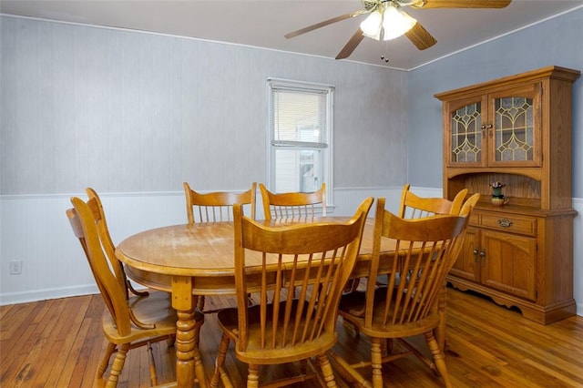 dining space with light wood-type flooring and ceiling fan