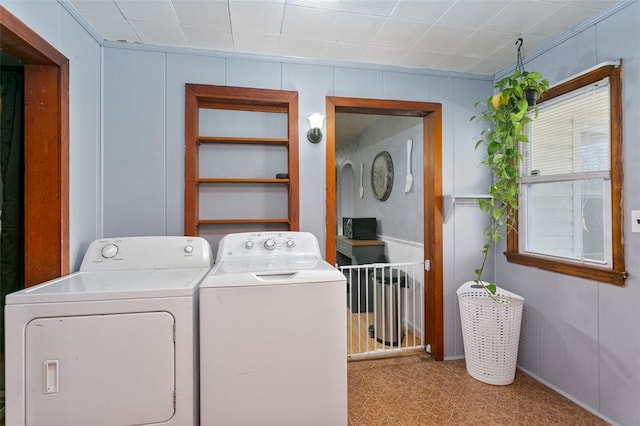 laundry room featuring washer and clothes dryer and light carpet