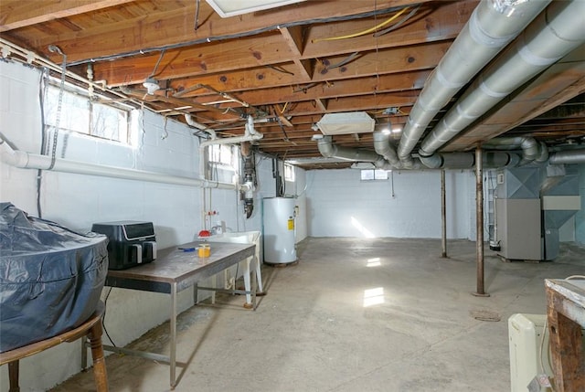 basement featuring heating unit and water heater