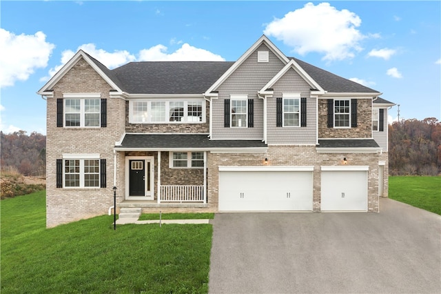 view of front of property with a garage and a front yard