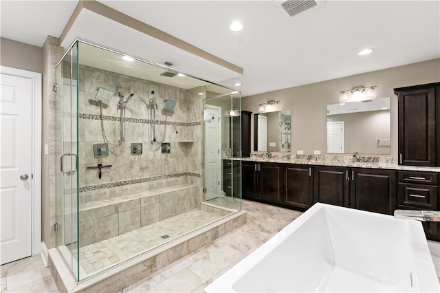 bathroom featuring shower with separate bathtub and vanity