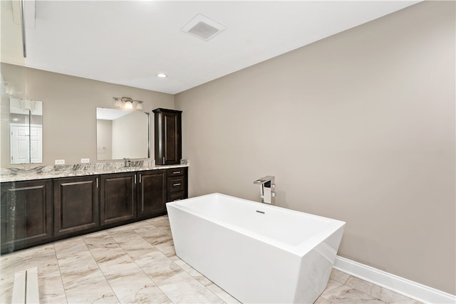 bathroom featuring a washtub and vanity