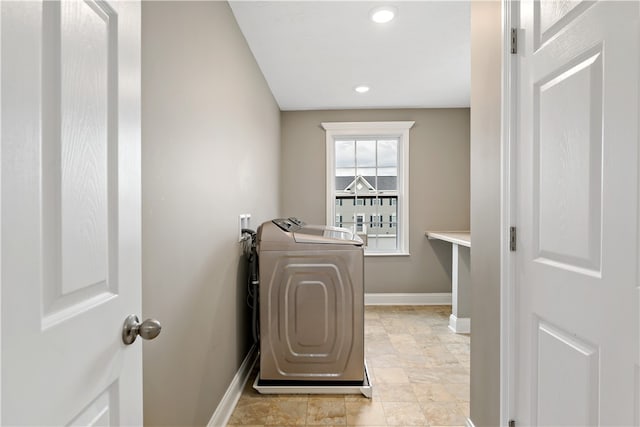 clothes washing area with washer and clothes dryer