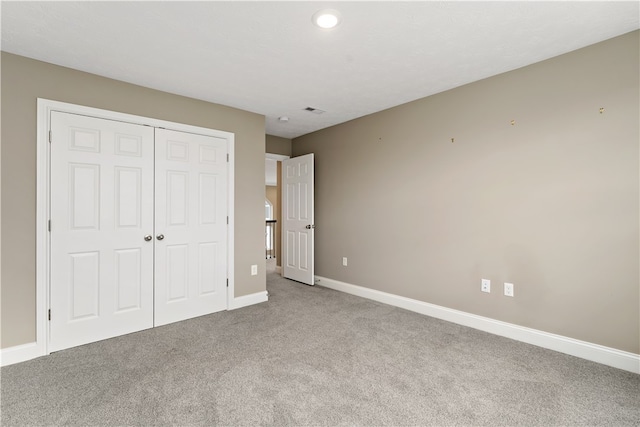 unfurnished bedroom with carpet and a closet