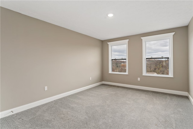 unfurnished room featuring light colored carpet