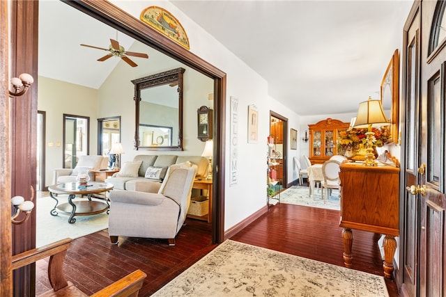 interior space with dark hardwood / wood-style flooring, lofted ceiling, and ceiling fan