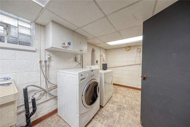 laundry room with cabinets and washing machine and dryer