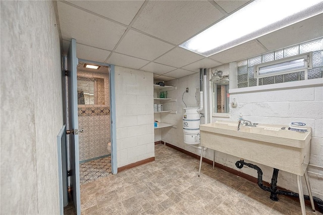 bathroom with a drop ceiling and toilet