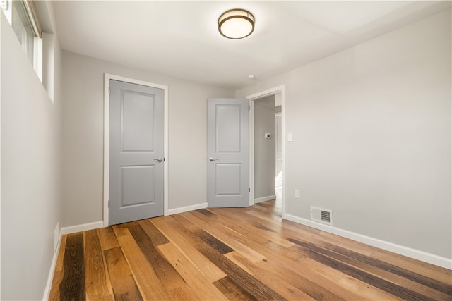 unfurnished bedroom featuring hardwood / wood-style flooring