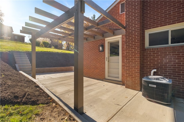 view of patio featuring a pergola and central AC