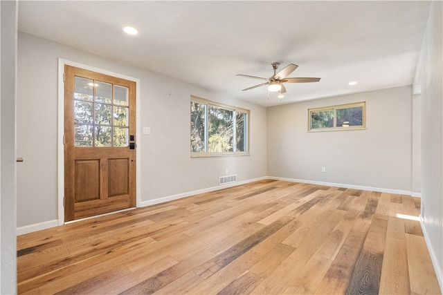 entrance foyer with a wealth of natural light, ceiling fan, and light hardwood / wood-style flooring