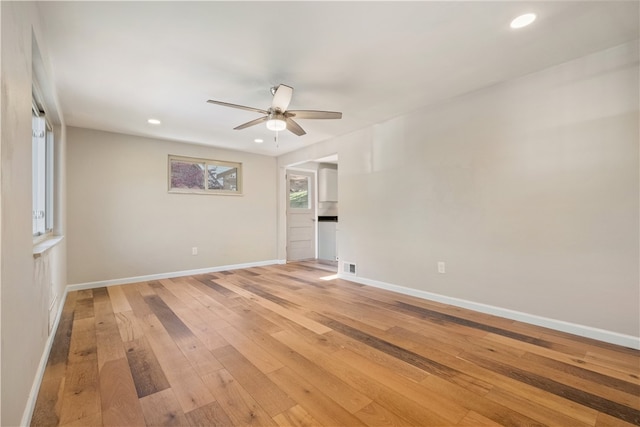 empty room featuring ceiling fan and light hardwood / wood-style flooring