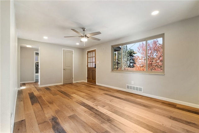 unfurnished room with ceiling fan and light wood-type flooring