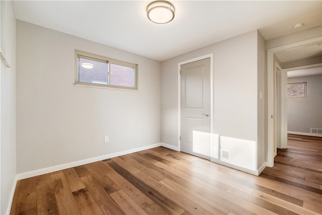 unfurnished bedroom featuring hardwood / wood-style floors and a closet