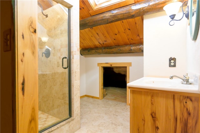 bathroom with vanity, a skylight, and a shower with door