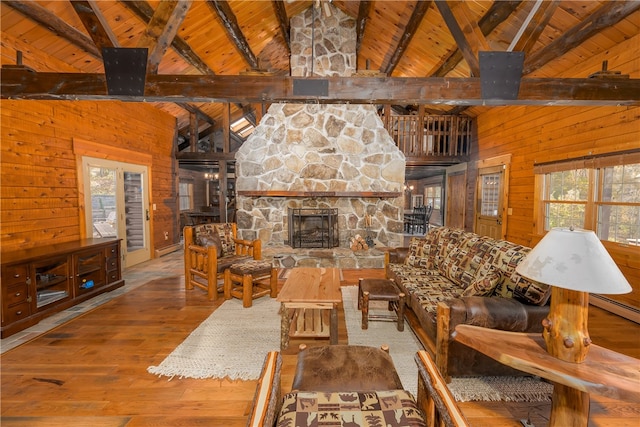 unfurnished living room with wooden walls, hardwood / wood-style flooring, wooden ceiling, and beam ceiling