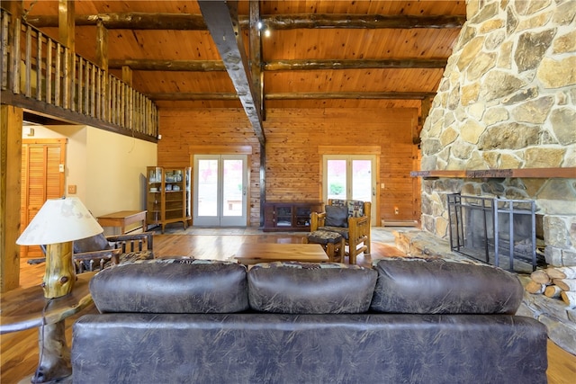 unfurnished living room featuring french doors, hardwood / wood-style floors, wooden ceiling, beam ceiling, and a fireplace