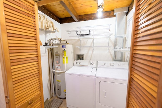 clothes washing area featuring water heater, tile patterned floors, wooden ceiling, and washing machine and clothes dryer