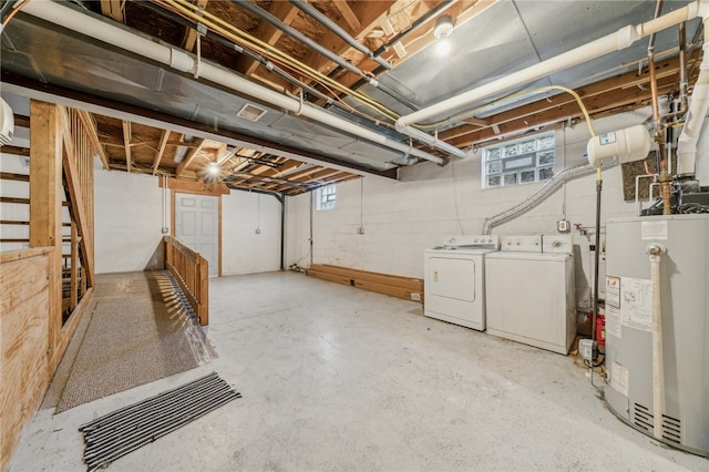 basement featuring water heater and washer and clothes dryer