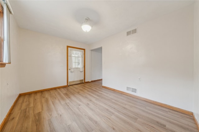 spare room featuring light hardwood / wood-style floors