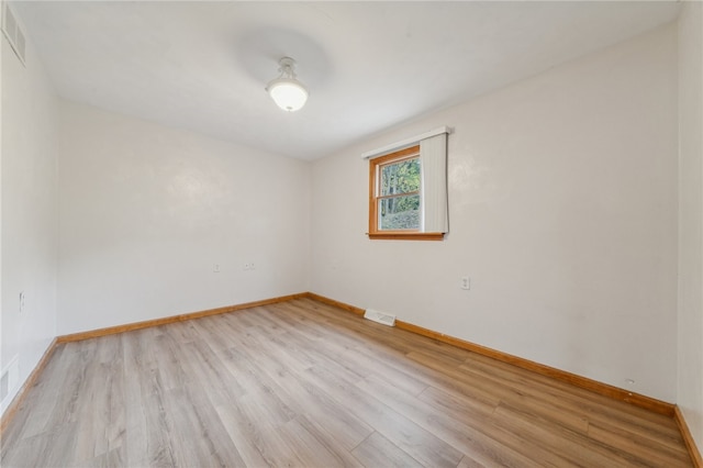 unfurnished room with light wood-type flooring