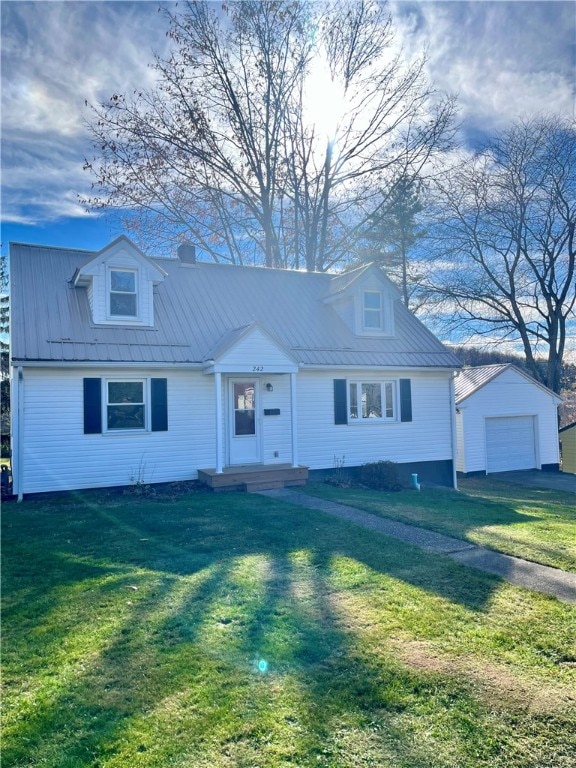 view of front of house featuring an outbuilding, a garage, and a front lawn