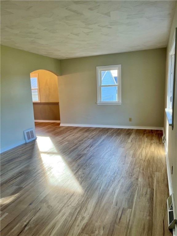 unfurnished room with wood-type flooring