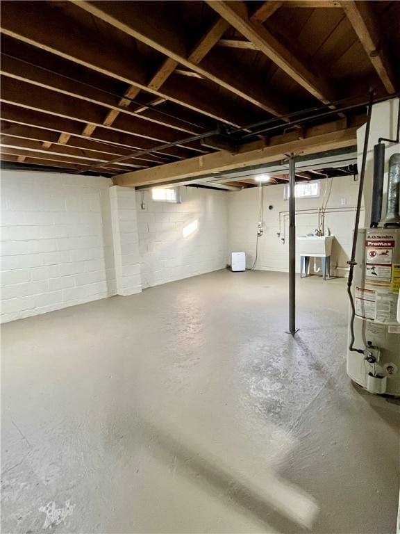 basement with water heater and sink