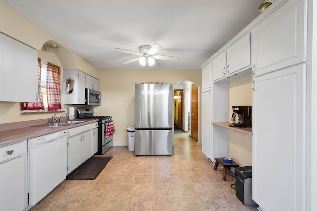 kitchen with appliances with stainless steel finishes, sink, and white cabinets