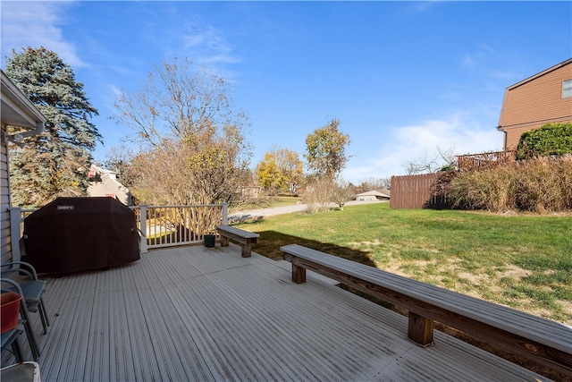 wooden deck with a lawn and a grill