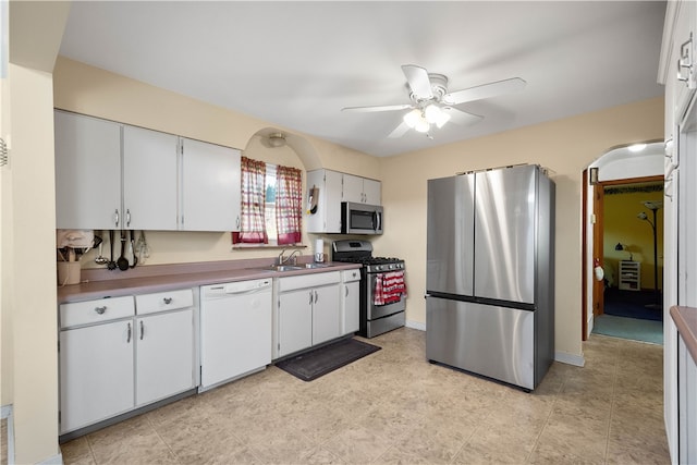 kitchen featuring white cabinetry, sink, ceiling fan, and stainless steel appliances