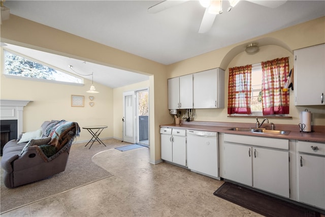 kitchen featuring white dishwasher, white cabinetry, sink, and lofted ceiling