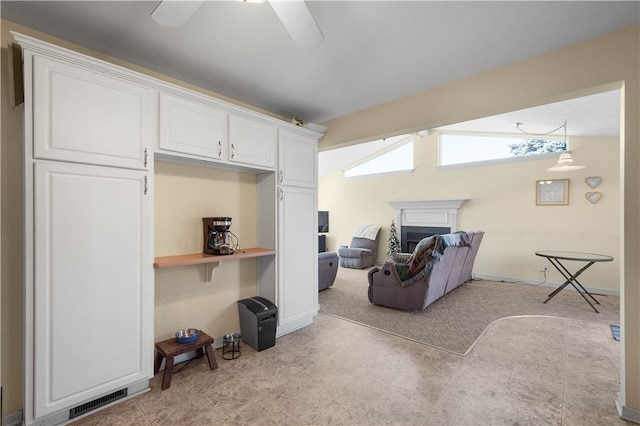 living room featuring vaulted ceiling and ceiling fan