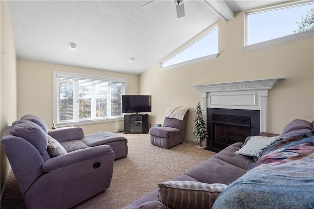 carpeted living room with ceiling fan and lofted ceiling with beams