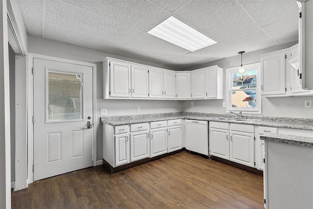 kitchen featuring white dishwasher, white cabinets, sink, and pendant lighting