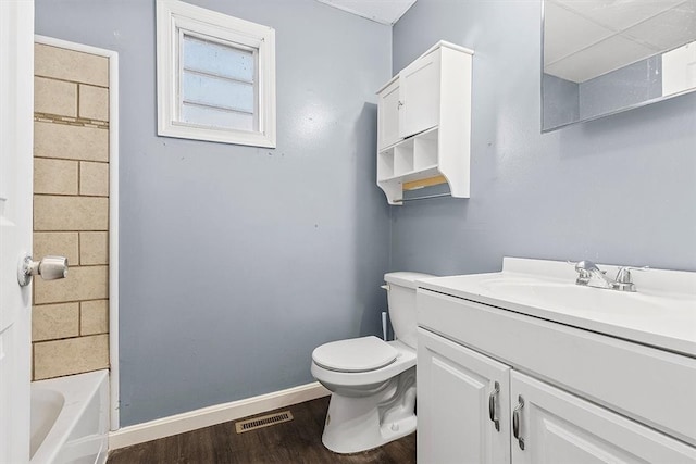 bathroom featuring wood-type flooring, vanity, and toilet