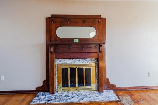 details featuring hardwood / wood-style flooring and a high end fireplace