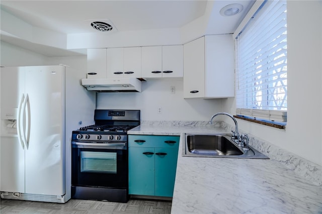 kitchen with white cabinets, stainless steel gas range, sink, and white refrigerator with ice dispenser