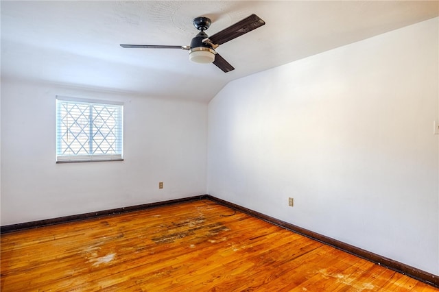 spare room with wood-type flooring, ceiling fan, and vaulted ceiling