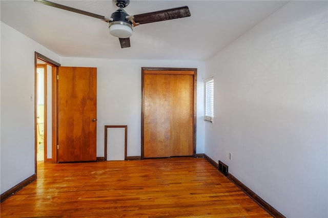 unfurnished bedroom with ceiling fan and light hardwood / wood-style flooring